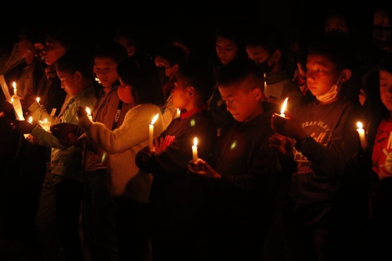 Children holding candles during a candle light service organized by the Peren Town Community in the main town square on March 24 in honor of the three persons who were killed by armed assailants on March 22 at Lamhainamdi Village under Peren district.